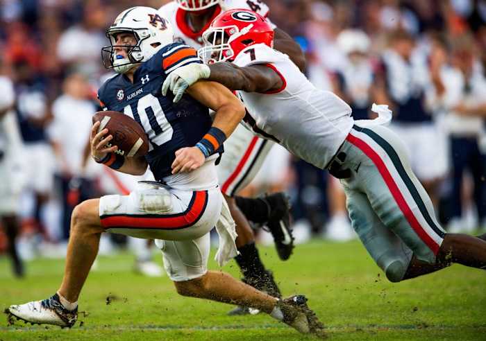 Auburn Tigers quarterback Bo Nix (10) is sacked by Georgia Bulldogs linebacker Quay Walker (7). Jake Crandall / USA TODAY NETWORK